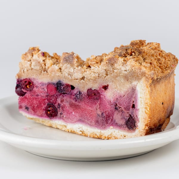A slice of Kudo Society Cafe's berry crumble pie with a thick, fruity filling.